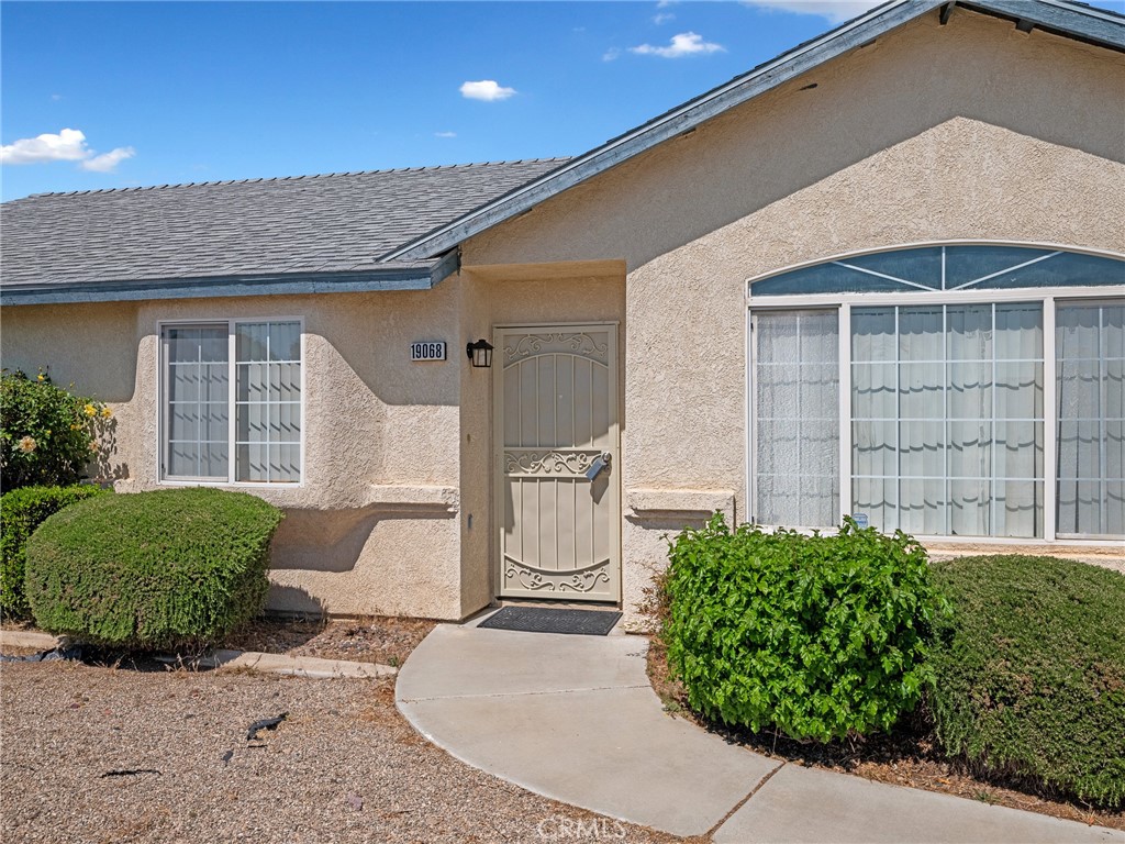 19068 Goleta Street Hesperia, CA 92345 - Photo 32 of 34 a front view of a house with a yard and garage