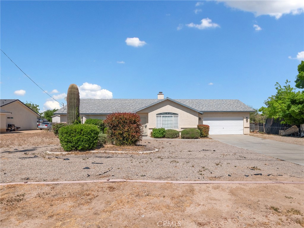 19068 Goleta Street Hesperia, CA 92345 - Photo 33 of 34 a front view of a house with a yard