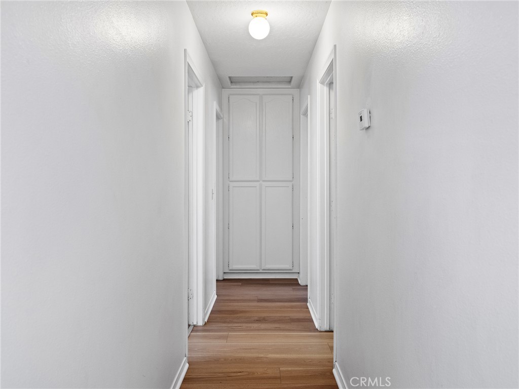19068 Goleta Street Hesperia, CA 92345 - Photo 7 of 34 a view of a hallway with wooden floor