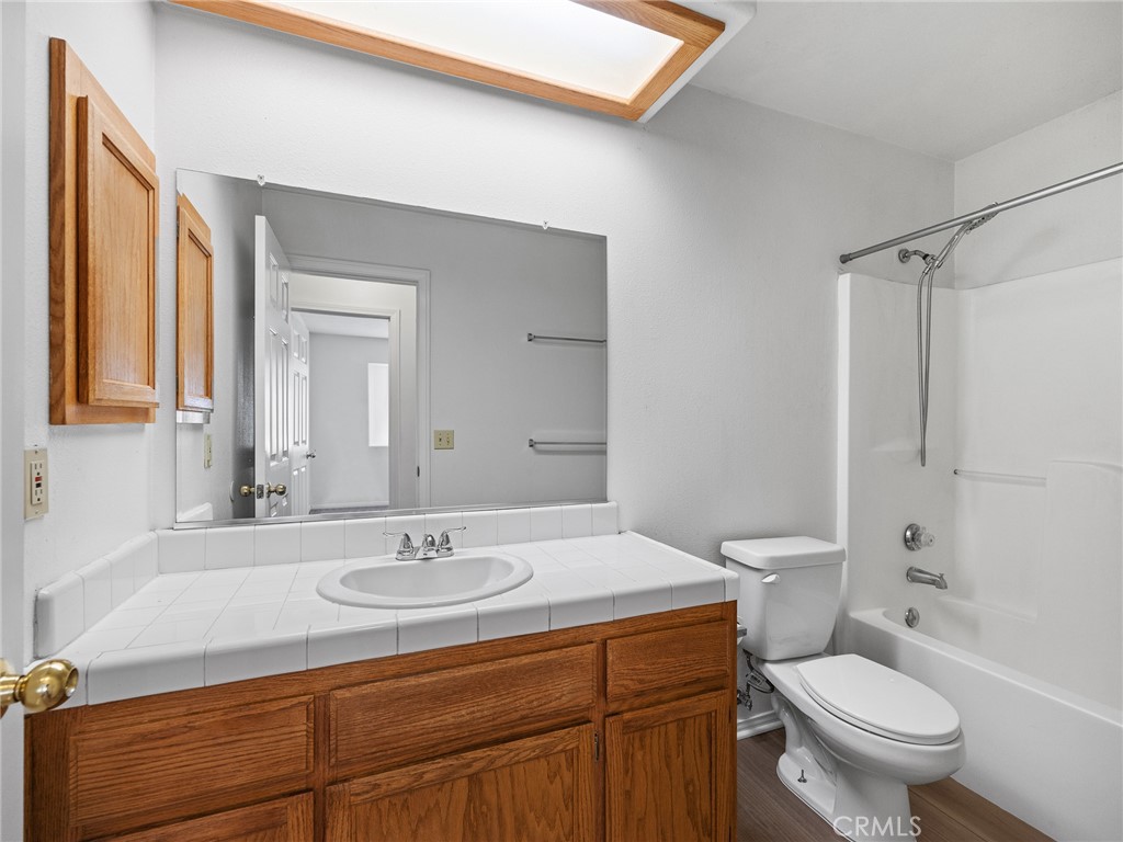 19068 Goleta Street Hesperia, CA 92345 - Photo 8 of 34 a bathroom with a sink toilet a mirror and shower
