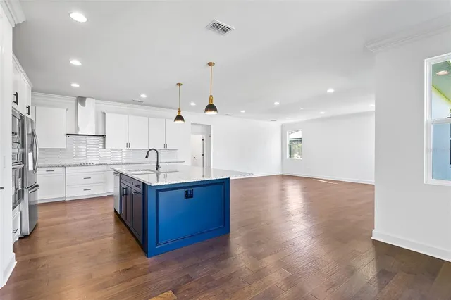 a view of a room with wooden floor garage and window