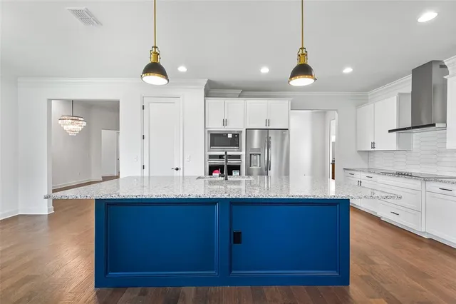 a view of an empty room with wooden floor and closet