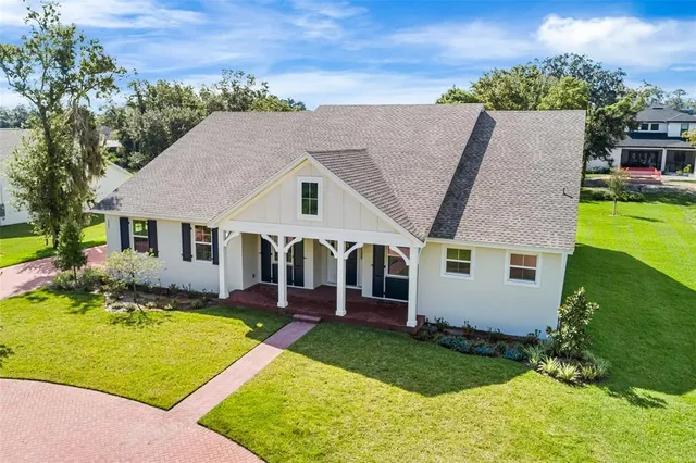 an aerial view of house with yard swimming pool and ocean view