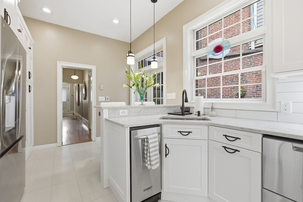 419 Main Street Boston, MA 02129 - Photo 12 of 41 a kitchen with stainless steel appliances granite countertop a sink and a refrigerator