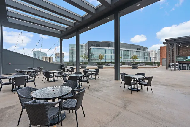 a view of a patio with dining table and chairs