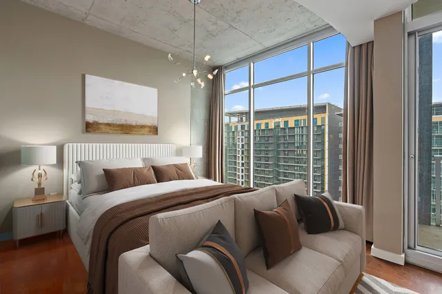 a bed sitting in a bedroom next to a window