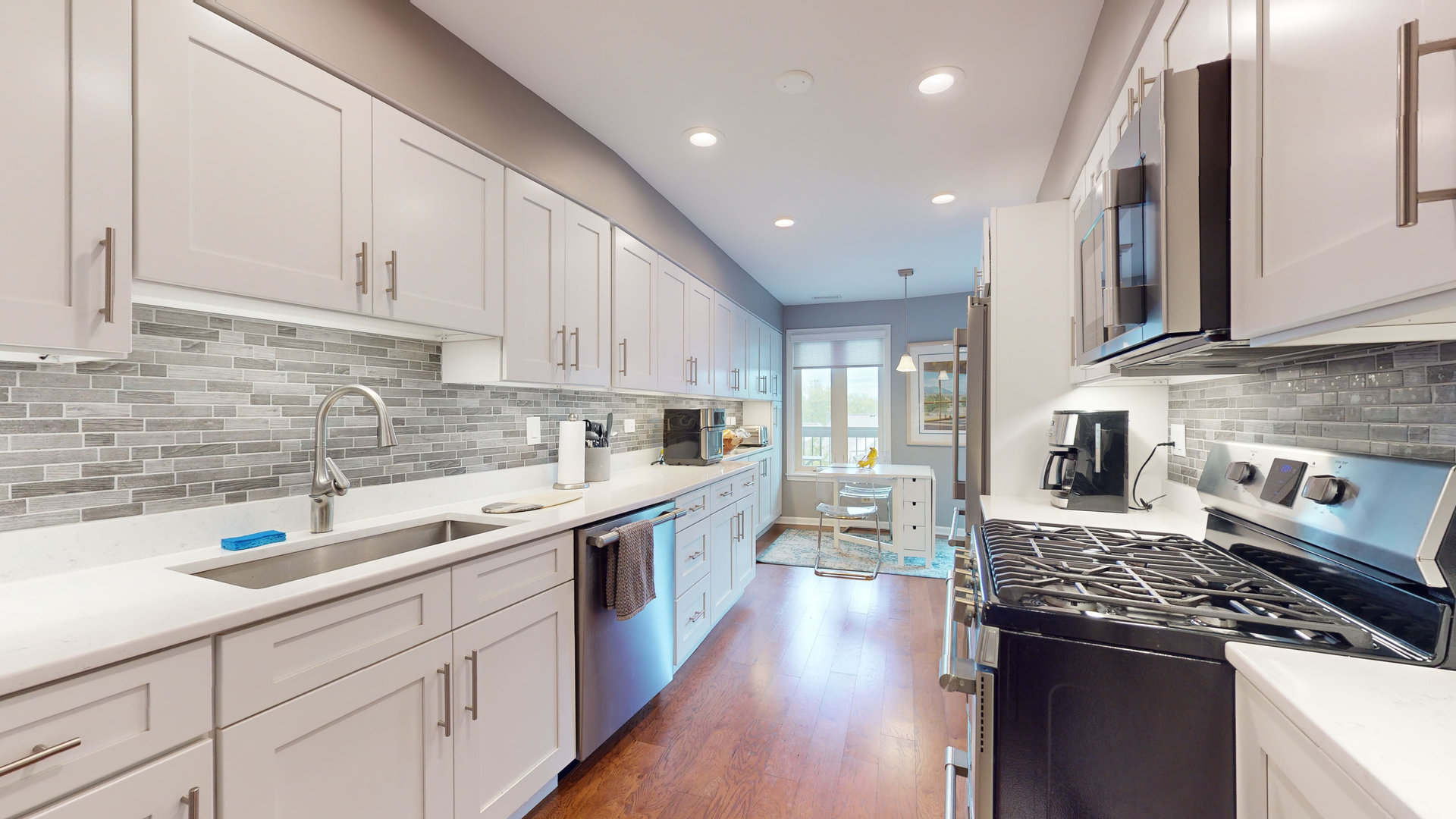 400 East Dundee Road, Unit 307 Buffalo Grove, IL 60089 - Photo 11 of 33 a large kitchen with stainless steel appliances granite countertop a lot of counter space and wooden floors