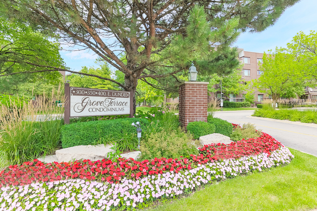 400 East Dundee Road, Unit 307 Buffalo Grove, IL 60089 - Photo 2 of 33 a green field with flowers and trees