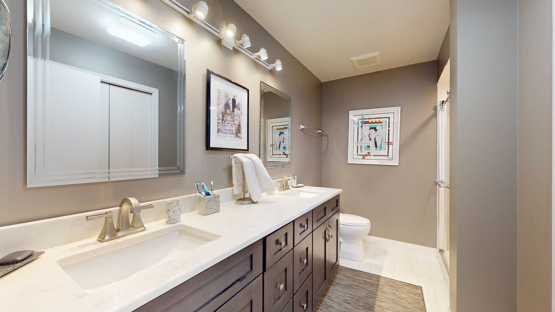 400 East Dundee Road, Unit 307 Buffalo Grove, IL 60089 - Photo 21 of 33 a bathroom with a double vanity sink mirror and toilet