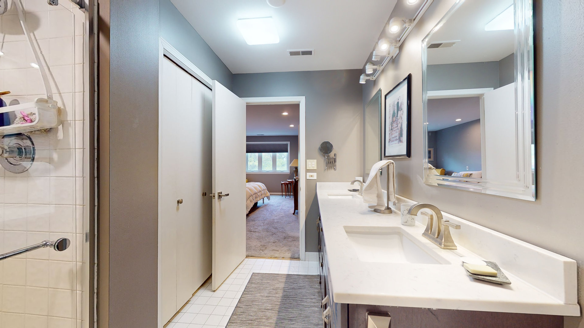 400 East Dundee Road, Unit 307 Buffalo Grove, IL 60089 - Photo 22 of 33 a en suite bathroom with a sink a mirror and shower