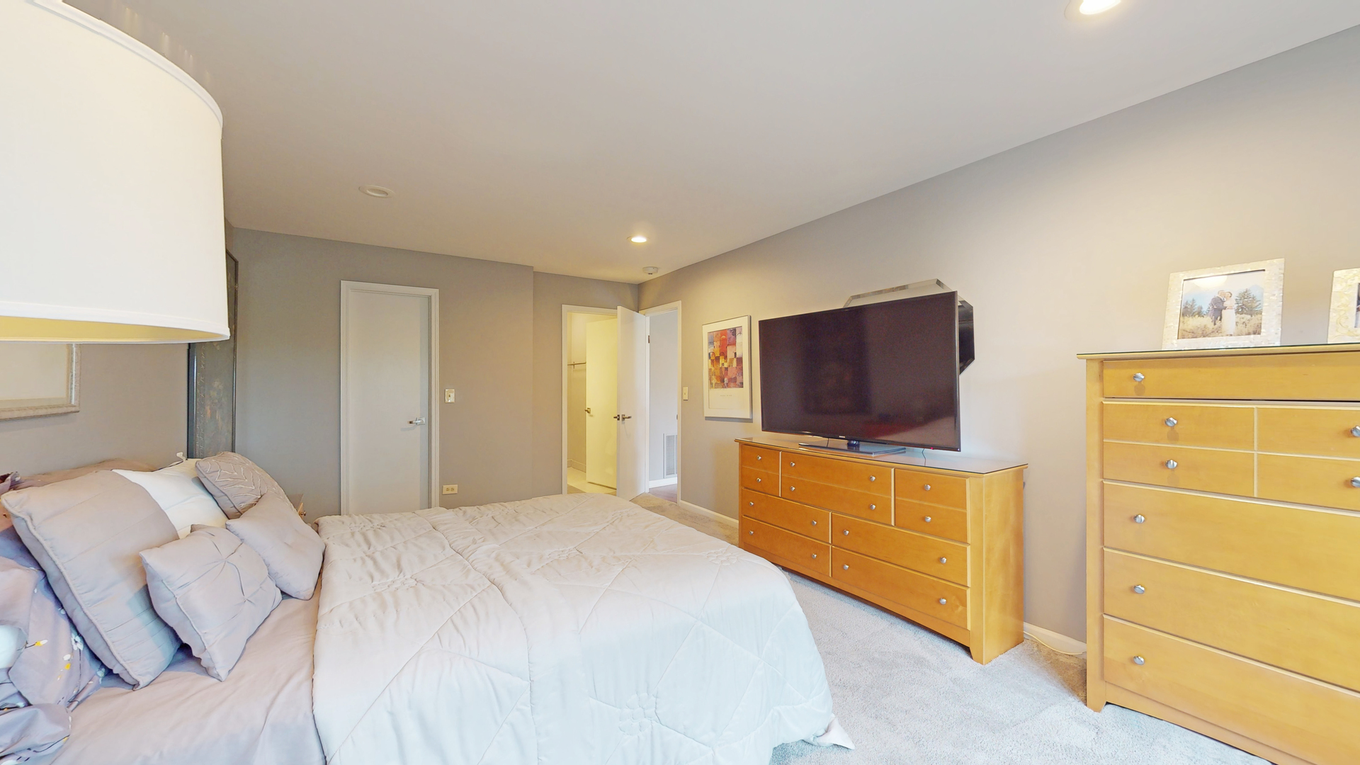 400 East Dundee Road, Unit 307 Buffalo Grove, IL 60089 - Photo 24 of 33 a bedroom with a bed and flat screen tv