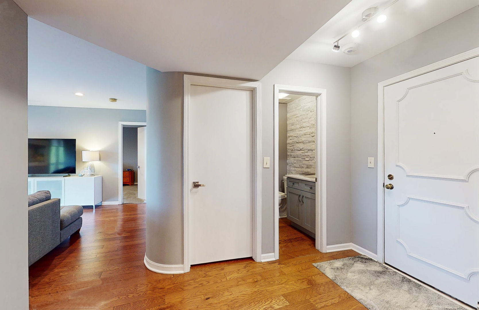 400 East Dundee Road, Unit 307 Buffalo Grove, IL 60089 - Photo 4 of 33 a view of a hallway with bathroom and wooden floor