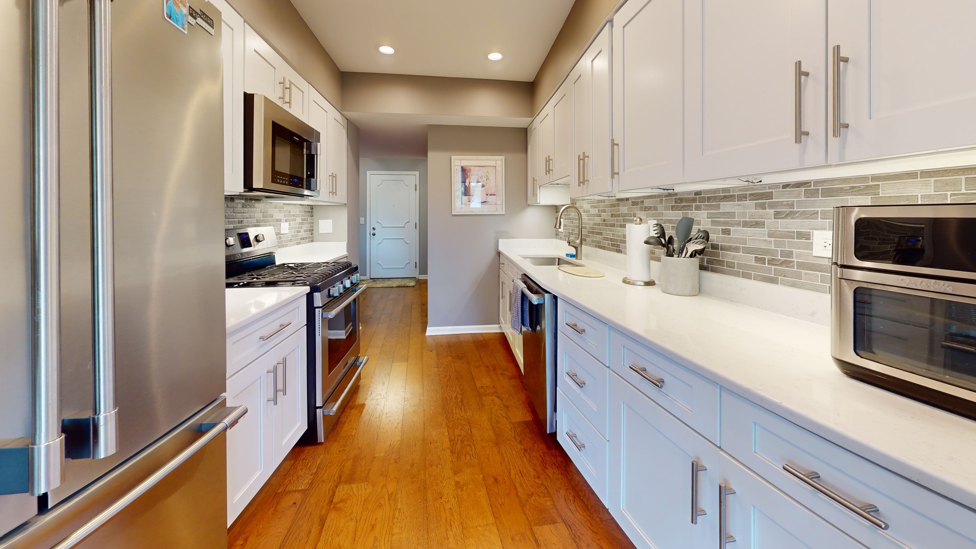400 East Dundee Road, Unit 307 Buffalo Grove, IL 60089 - Photo 10 of 33 a kitchen with kitchen island granite countertop a sink appliances cabinets and a counter top space