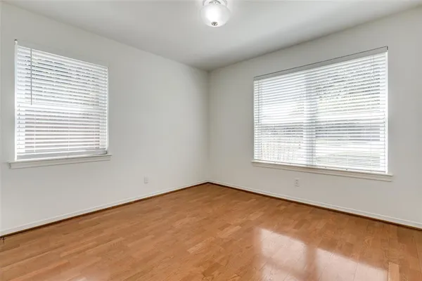 a view of kitchen with cabinets stainless steel appliances and wooden floor