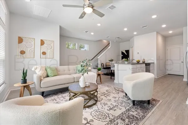 a living room with furniture and a chandelier