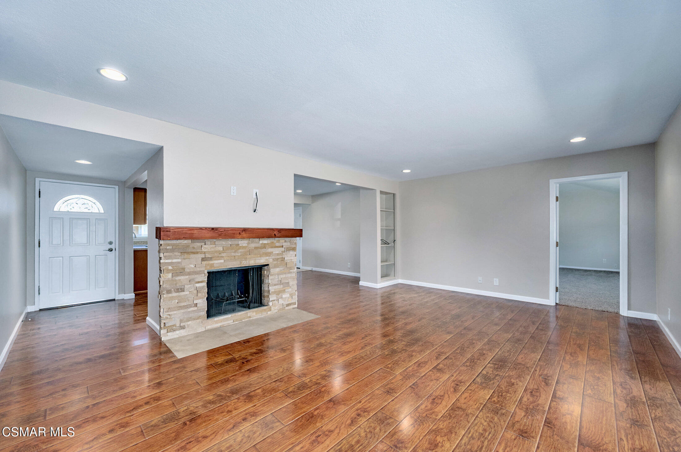 560 Randy Drive Newbury Park, CA 91320 - Photo 13 of 39 an empty room with wooden floor and fireplace