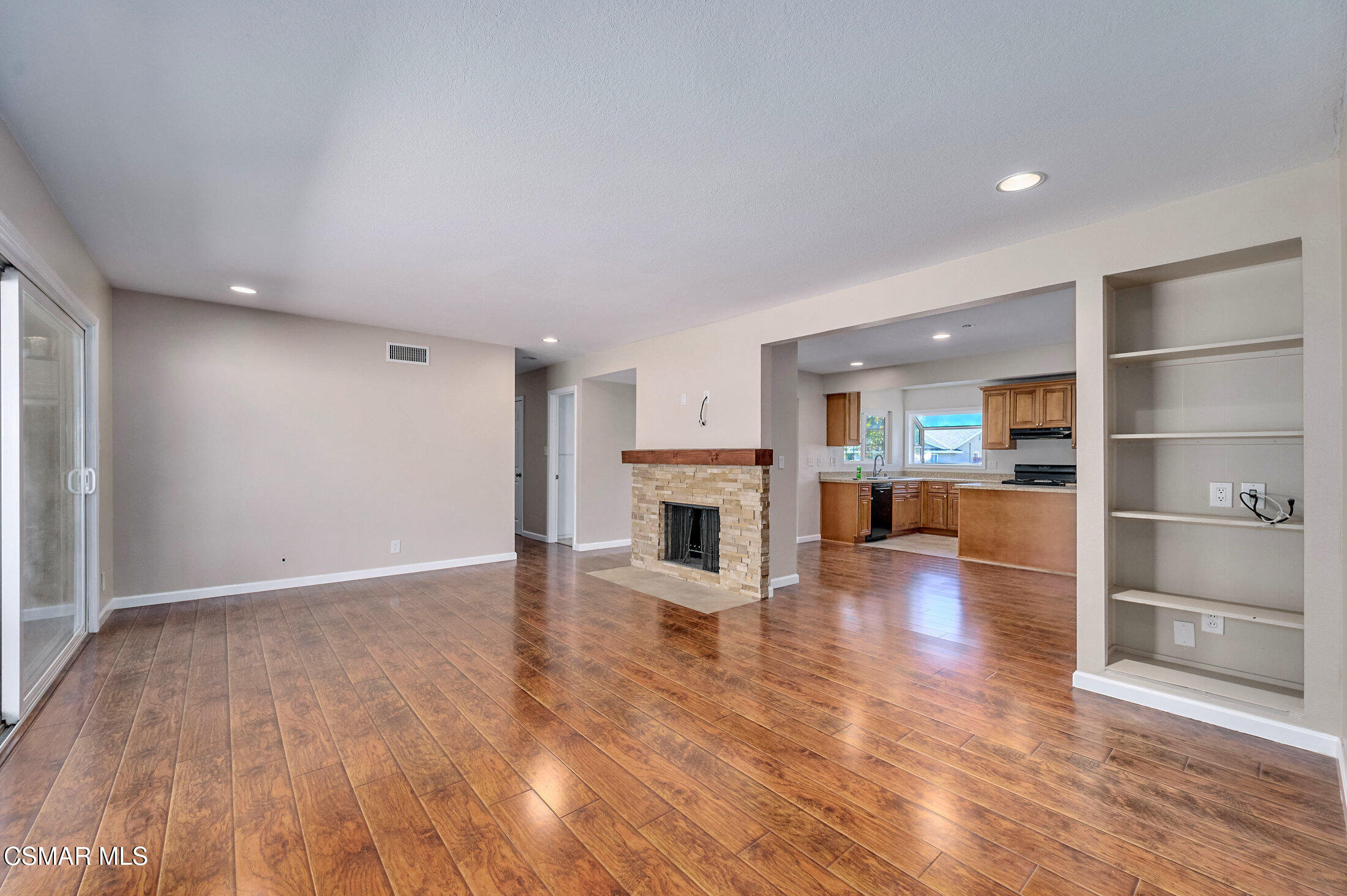 560 Randy Drive Newbury Park, CA 91320 - Photo 16 of 39 a view of a living room a kitchen with wooden floor and a fireplace