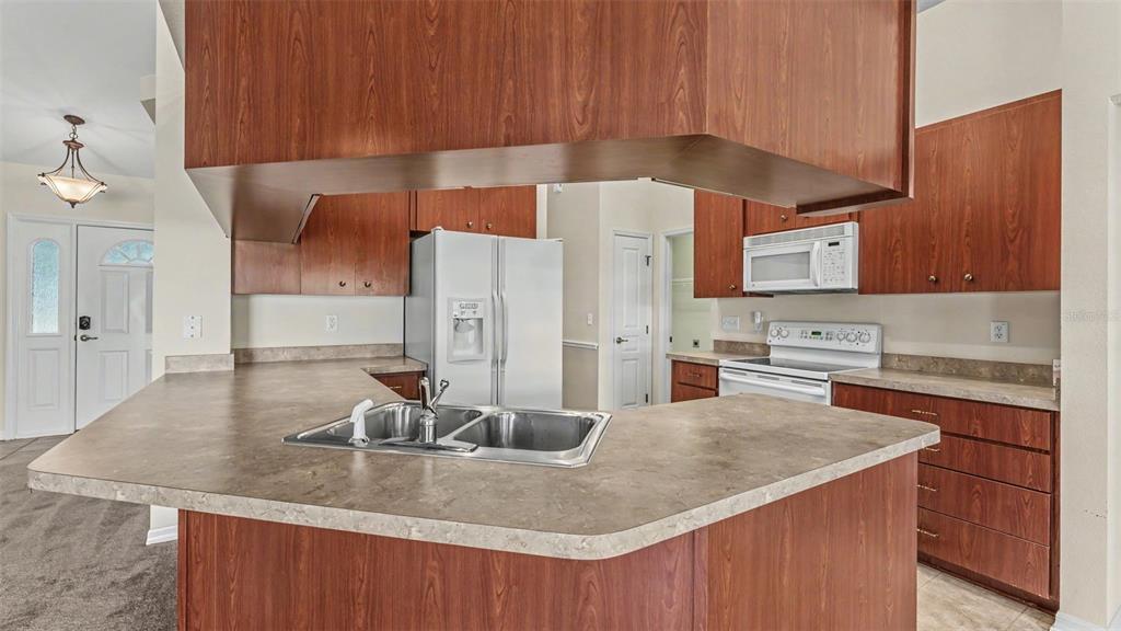 8525 North Campbell Road Lakeland, FL 33810 - Photo 31 of 45 a kitchen with stainless steel appliances granite countertop a sink a stove and a refrigerator