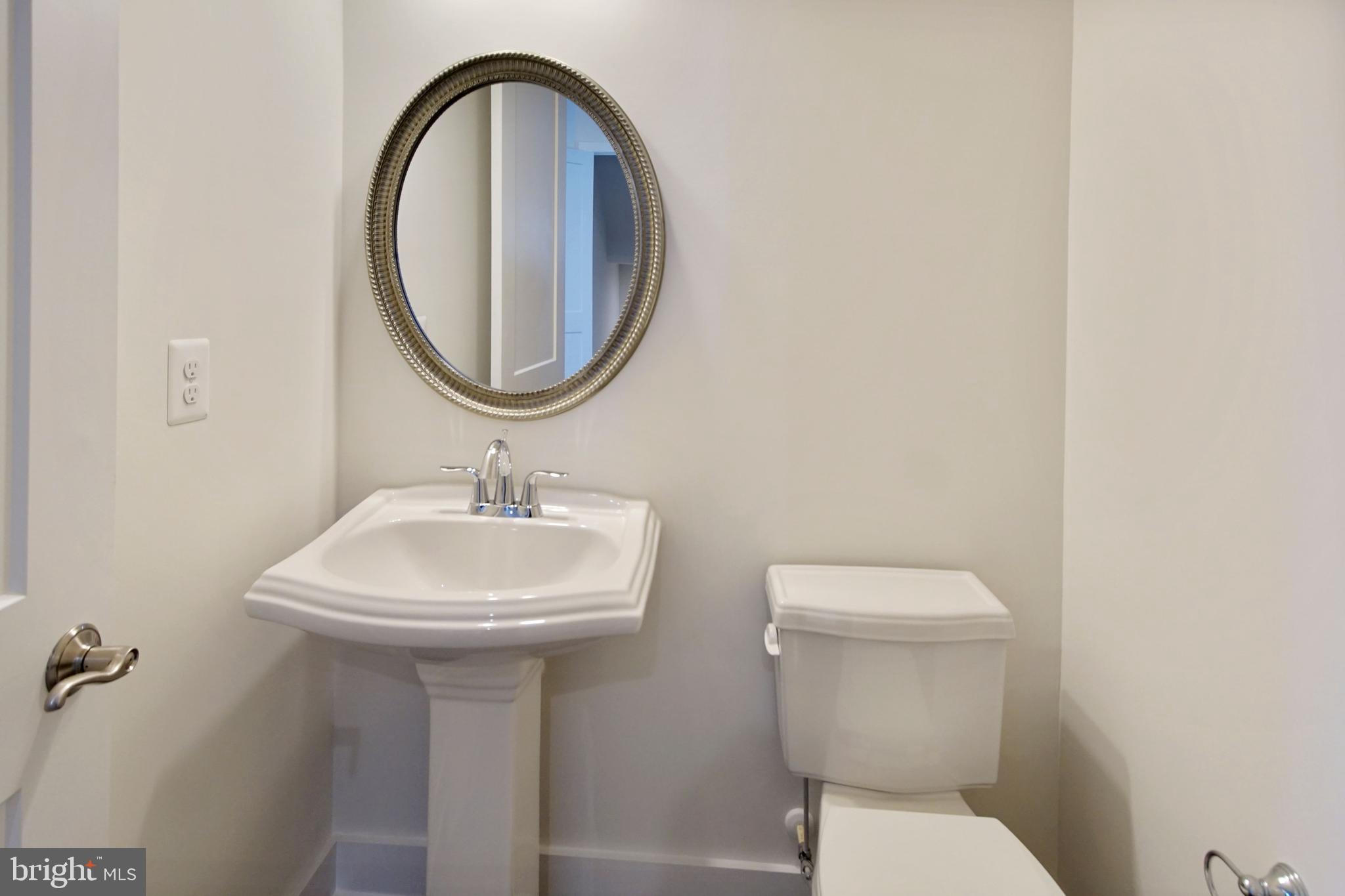 7405 Copper Lake Drive Hanover, MD 21076 - Photo 23 of 36 a bathroom with a sink a toilet and a mirror