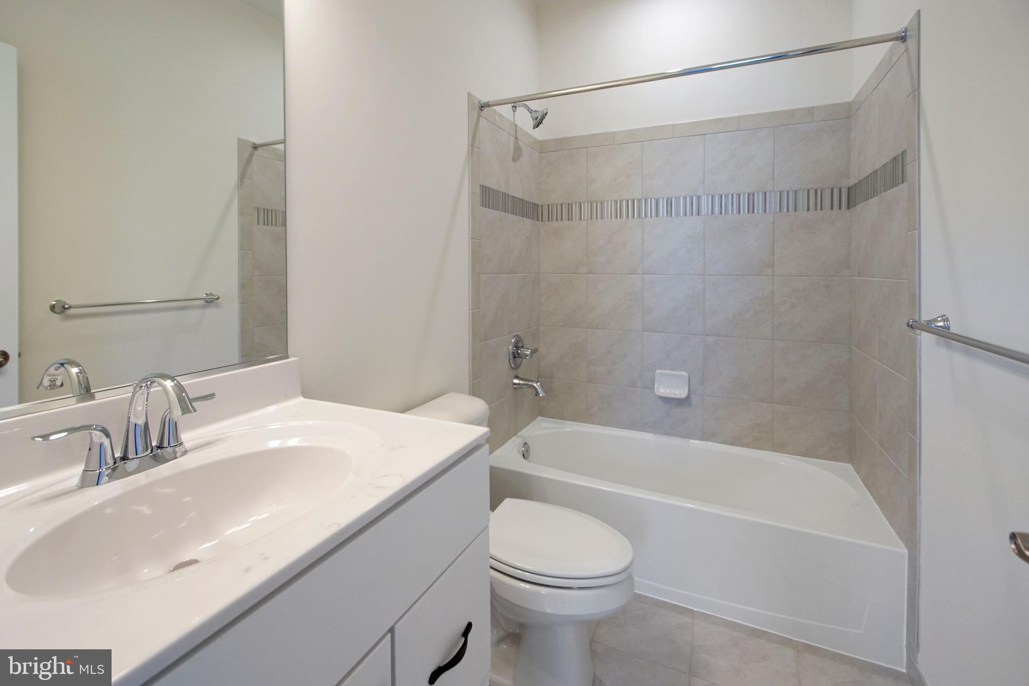 7405 Copper Lake Drive Hanover, MD 21076 - Photo 33 of 36 a bathroom with a sink a toilet and a bathtub
