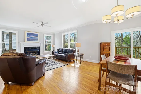 a living room with furniture a fireplace and a table
