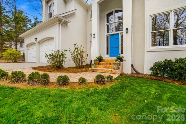 a view of a house with backyard and sitting area