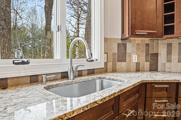 a kitchen with a sink and a wooden cabinets
