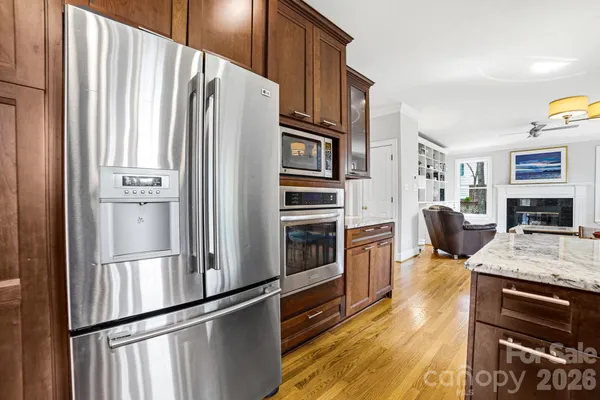 a kitchen with stainless steel appliances granite countertop a refrigerator stove and oven