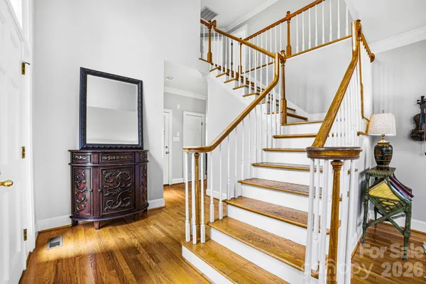 a view of entryway with wooden floor and stairs