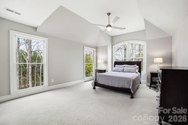 a spacious bedroom with a large bed and a window