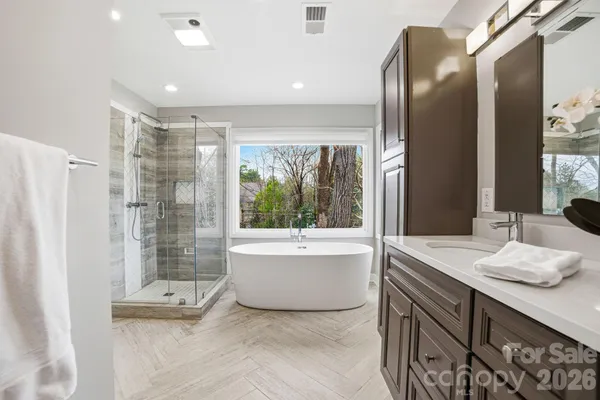 a bathroom with a tub sink and shower