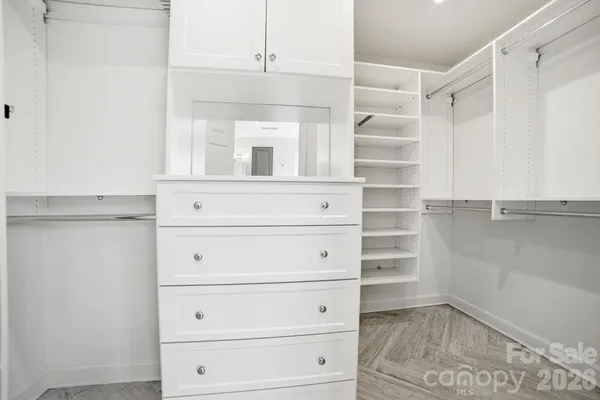 a view of walk in closet with empty racks
