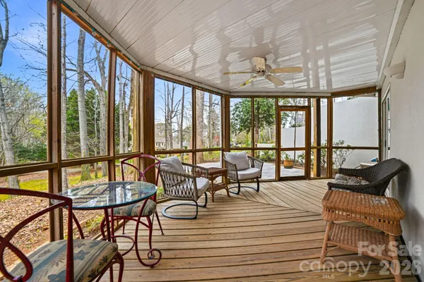 a living room with furniture and floor to ceiling windows