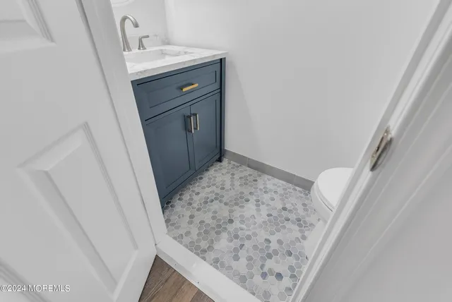 a bathroom with a sink vanity and a mirror