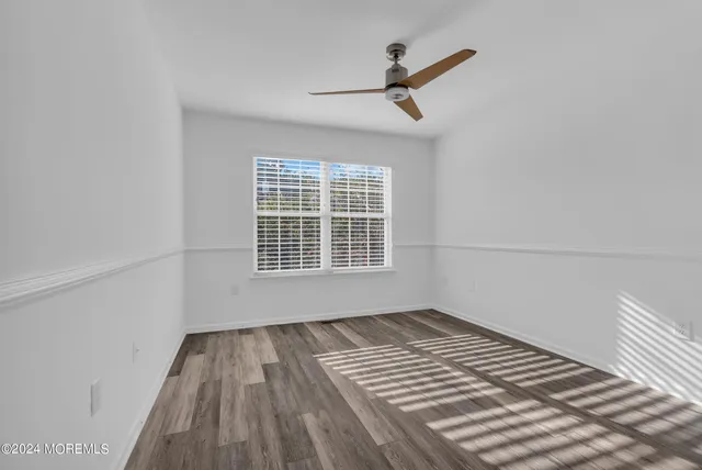 a bathroom with a bathtub a shower and a window
