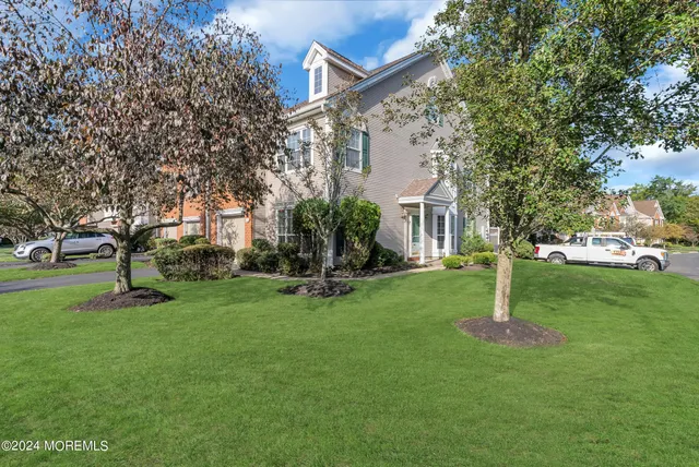 a front view of house with yard and green space