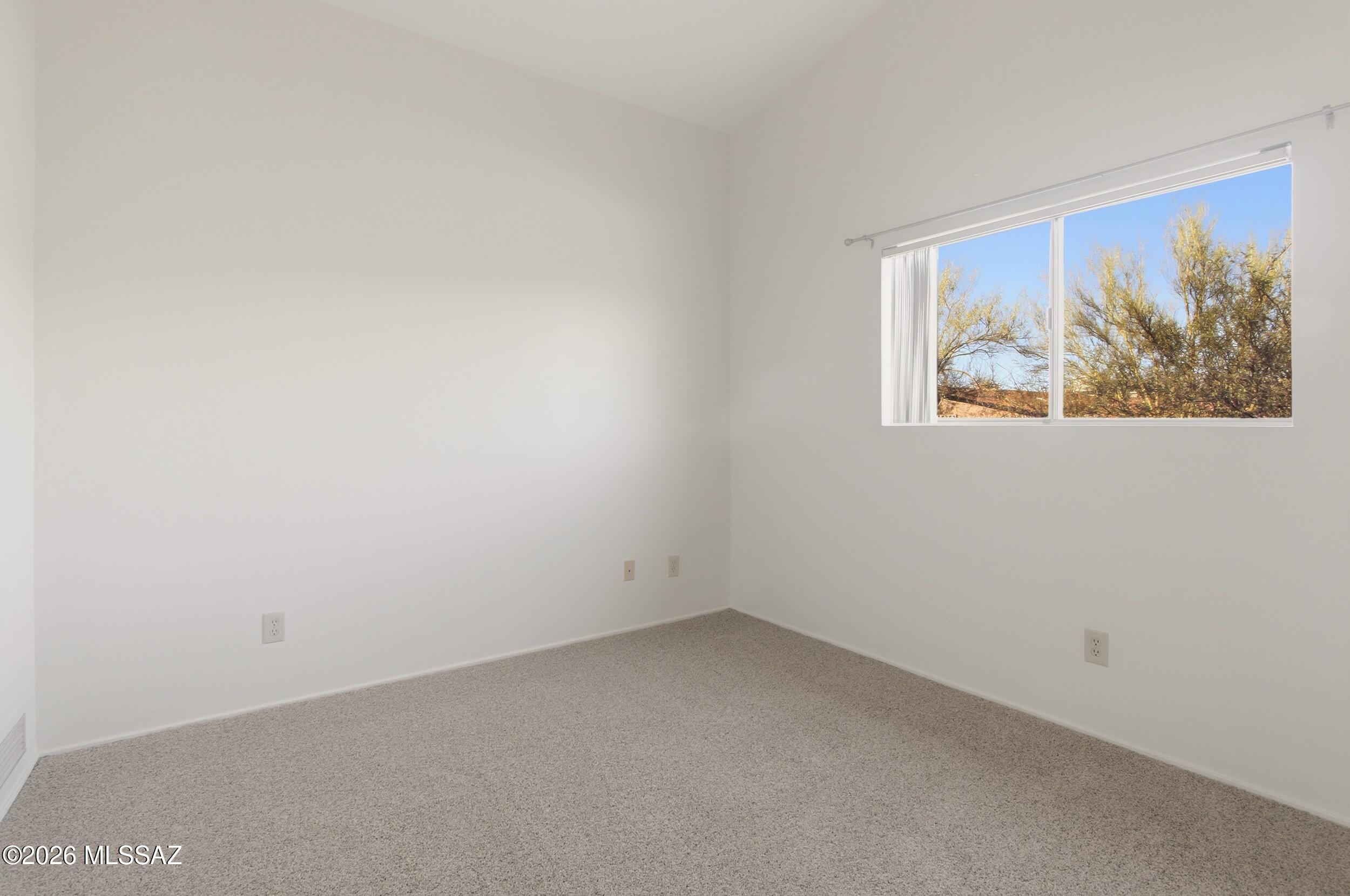9141 East Indian Canyon Road Tucson, AZ 85749 - Photo 24 of 33 an empty room with a window