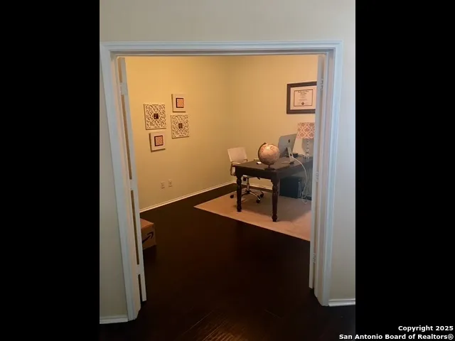 a view of workspace filled with furniture and wooden floor