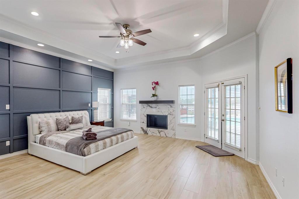 4908 Glenwood Lane Anna, TX 75409 - Photo 11 of 34 Bedroom featuring access to exterior, a tray ceiling, light wood-style floors, ceiling fan, and recessed lighting