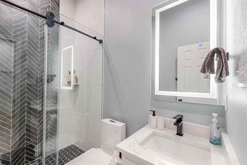 4908 Glenwood Lane Anna, TX 75409 - Photo 15 of 34 Full bath with a stall shower, vanity, and a textured wall