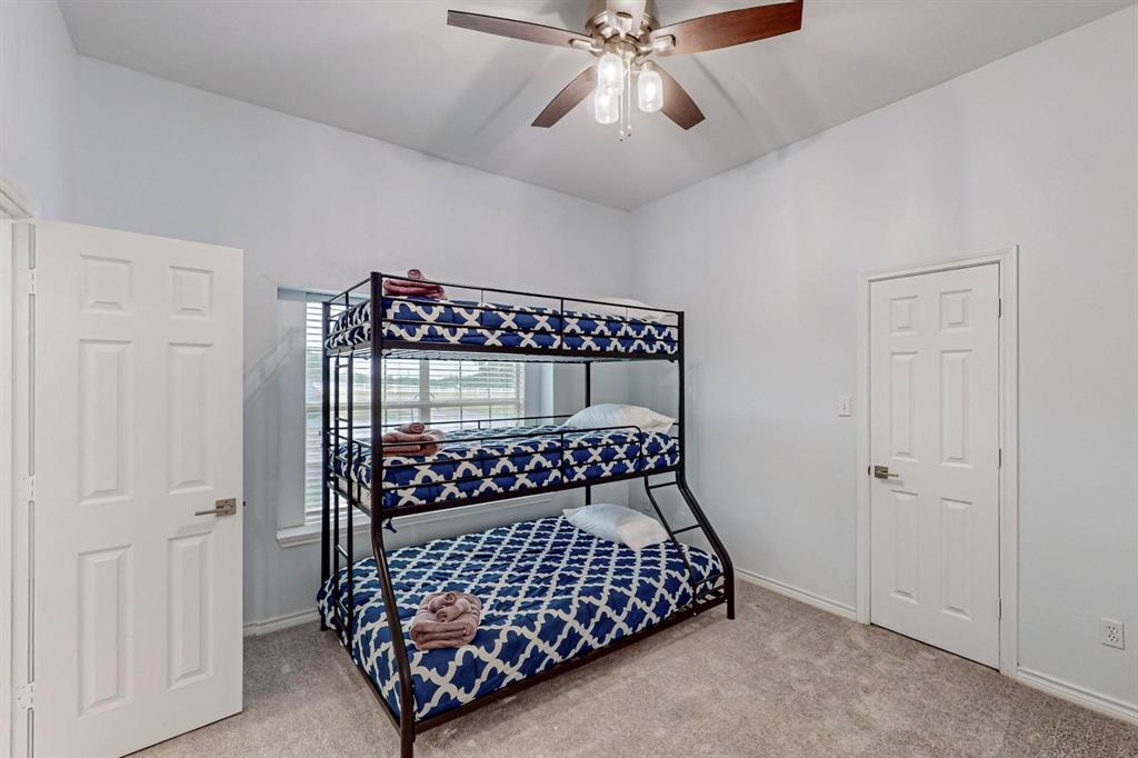 4908 Glenwood Lane Anna, TX 75409 - Photo 18 of 34 Bedroom with light carpet and ceiling fan