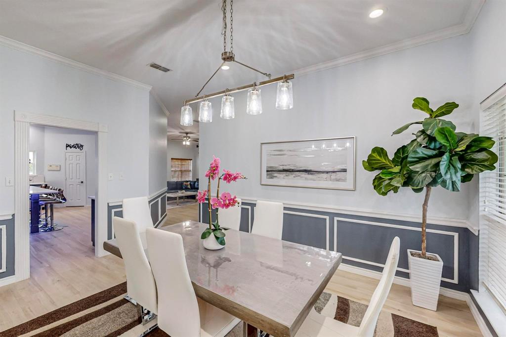 4908 Glenwood Lane Anna, TX 75409 - Photo 20 of 34 Dining space with ornamental molding, wainscoting, light wood-style flooring, a decorative wall, and a ceiling fan