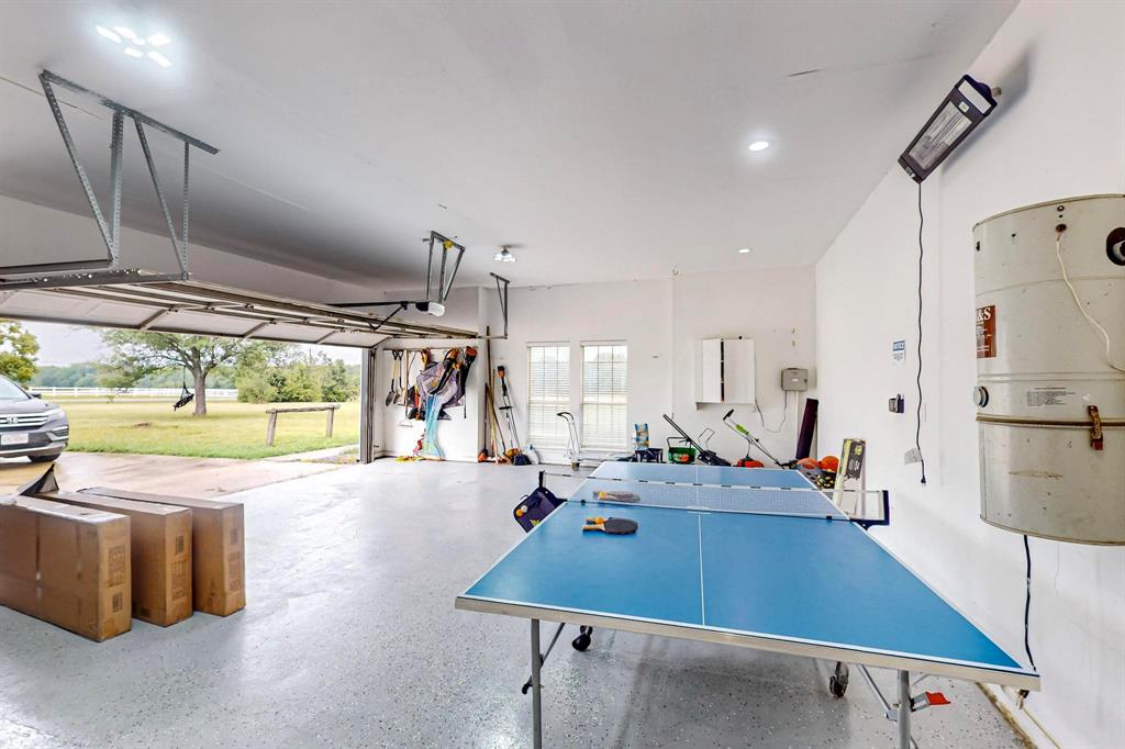 4908 Glenwood Lane Anna, TX 75409 - Photo 22 of 34 Garage featuring spacious parking spots, EV chargers and ping pong table