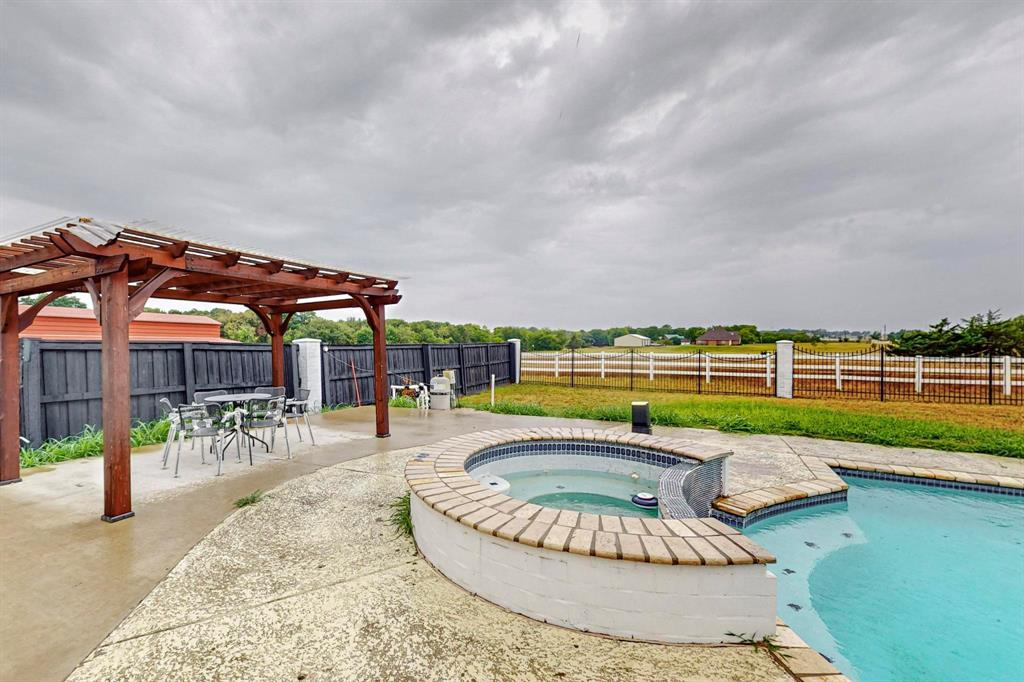 4908 Glenwood Lane Anna, TX 75409 - Photo 25 of 34 View of swimming pool with a patio, a fenced backyard, a pergola, an in-ground hot tub, and outdoor dining space
