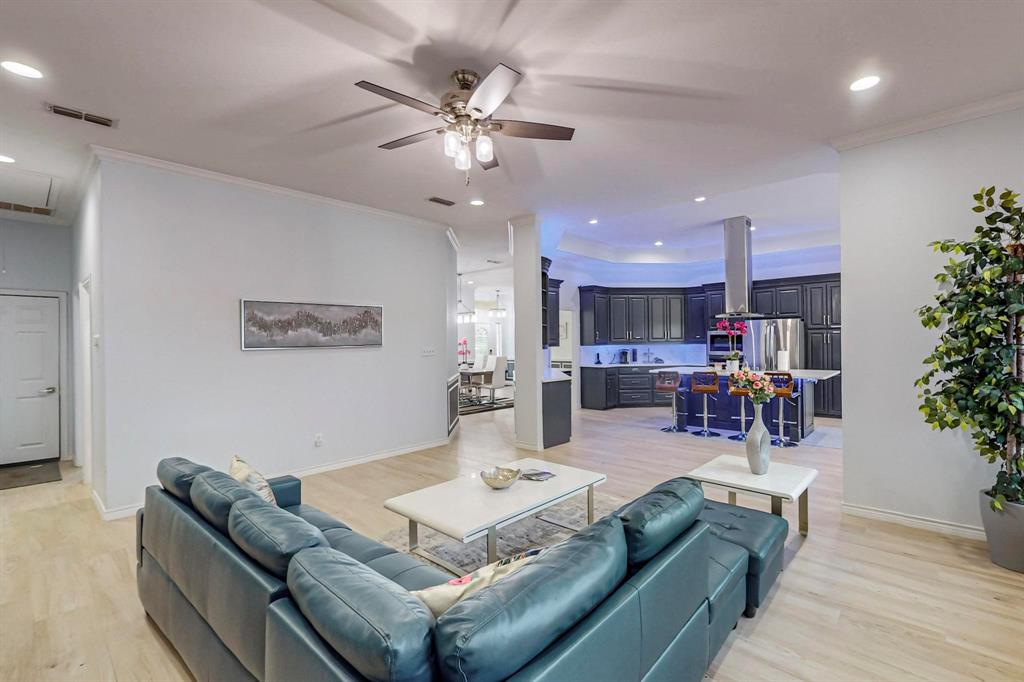 4908 Glenwood Lane Anna, TX 75409 - Photo 5 of 34 Living area featuring recessed lighting, light wood-style flooring, ornamental molding, and a ceiling fan