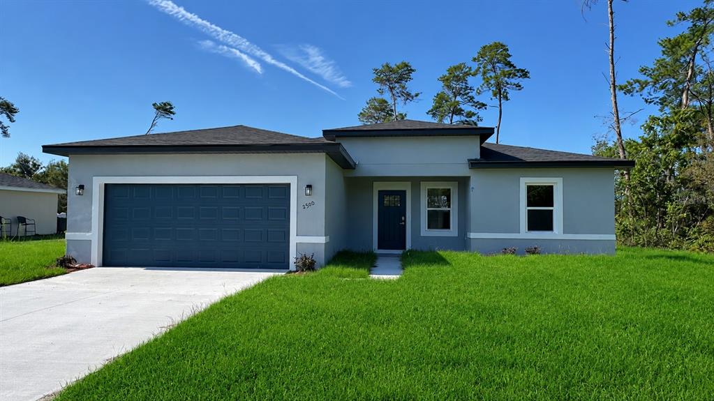 2500 Southwest 156th Lane Road Ocala, FL 34473 - Photo 1 of 15 a front view of a house with a garden