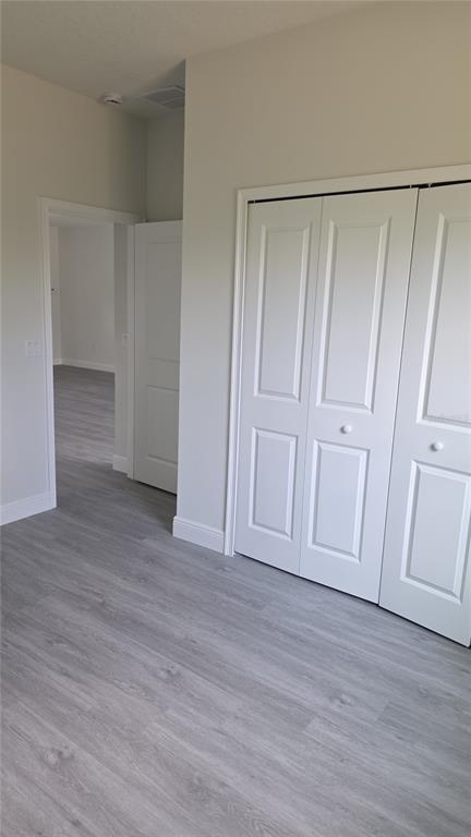 2500 Southwest 156th Lane Road Ocala, FL 34473 - Photo 13 of 15 a view of an empty room with wooden floor