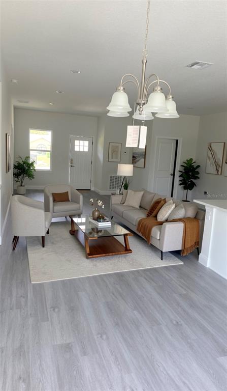 2500 Southwest 156th Lane Road Ocala, FL 34473 - Photo 2 of 15 a living room with furniture and a chandelier