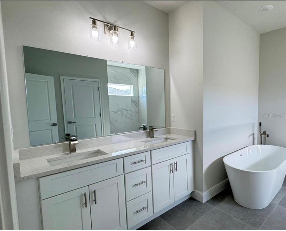 2500 Southwest 156th Lane Road Ocala, FL 34473 - Photo 9 of 15 a bathroom with a double vanity sink and a mirror