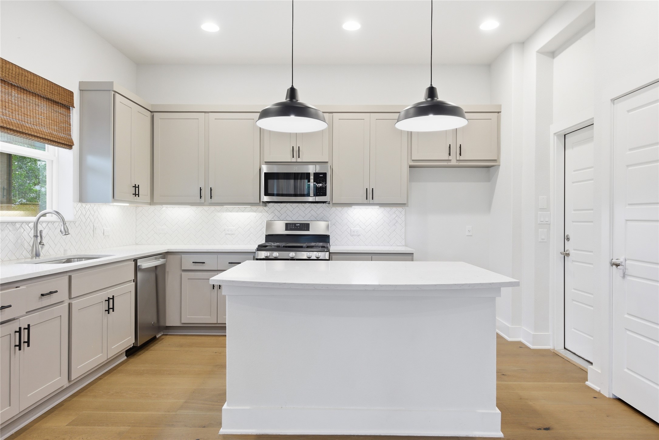 1300 Harwell Loop Kyle, TX 78640 - Photo 4 of 21 a kitchen with stainless steel appliances a sink a stove a refrigerator and white cabinets
